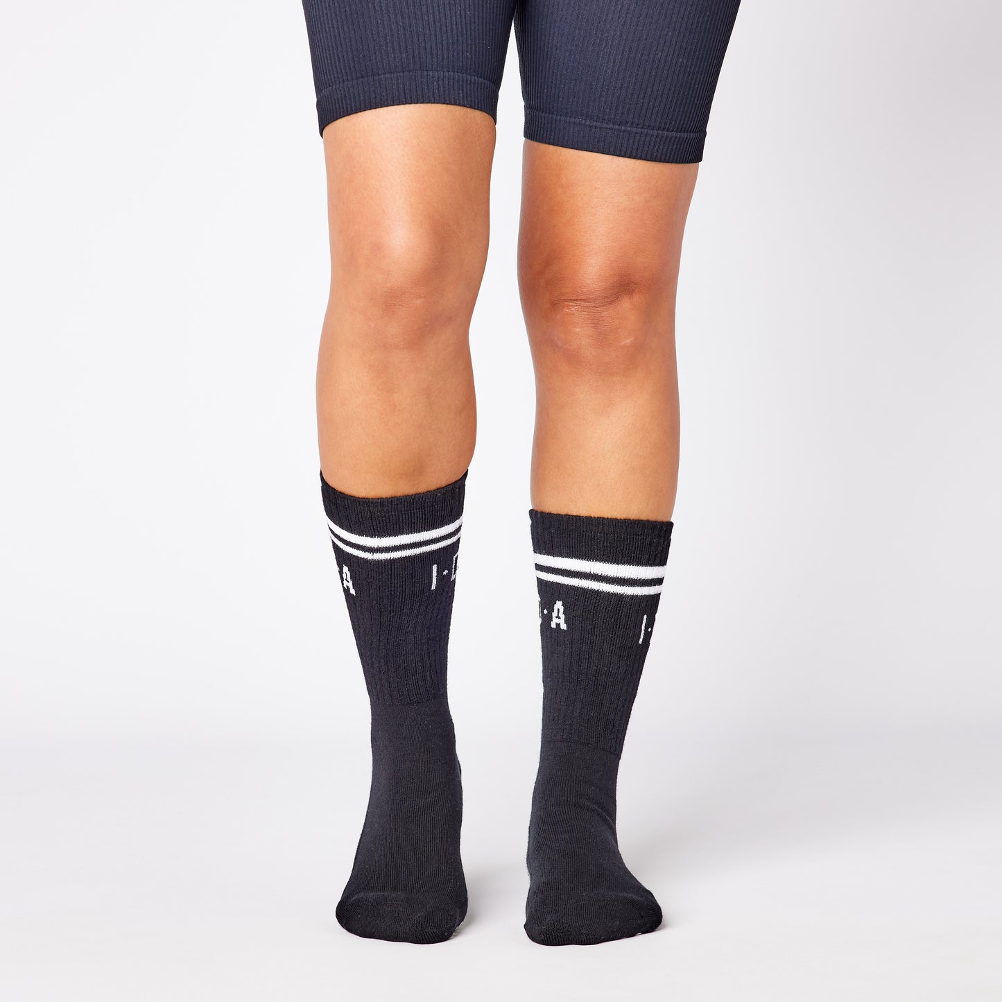 Black knee-high socks with white stripes and grip sole