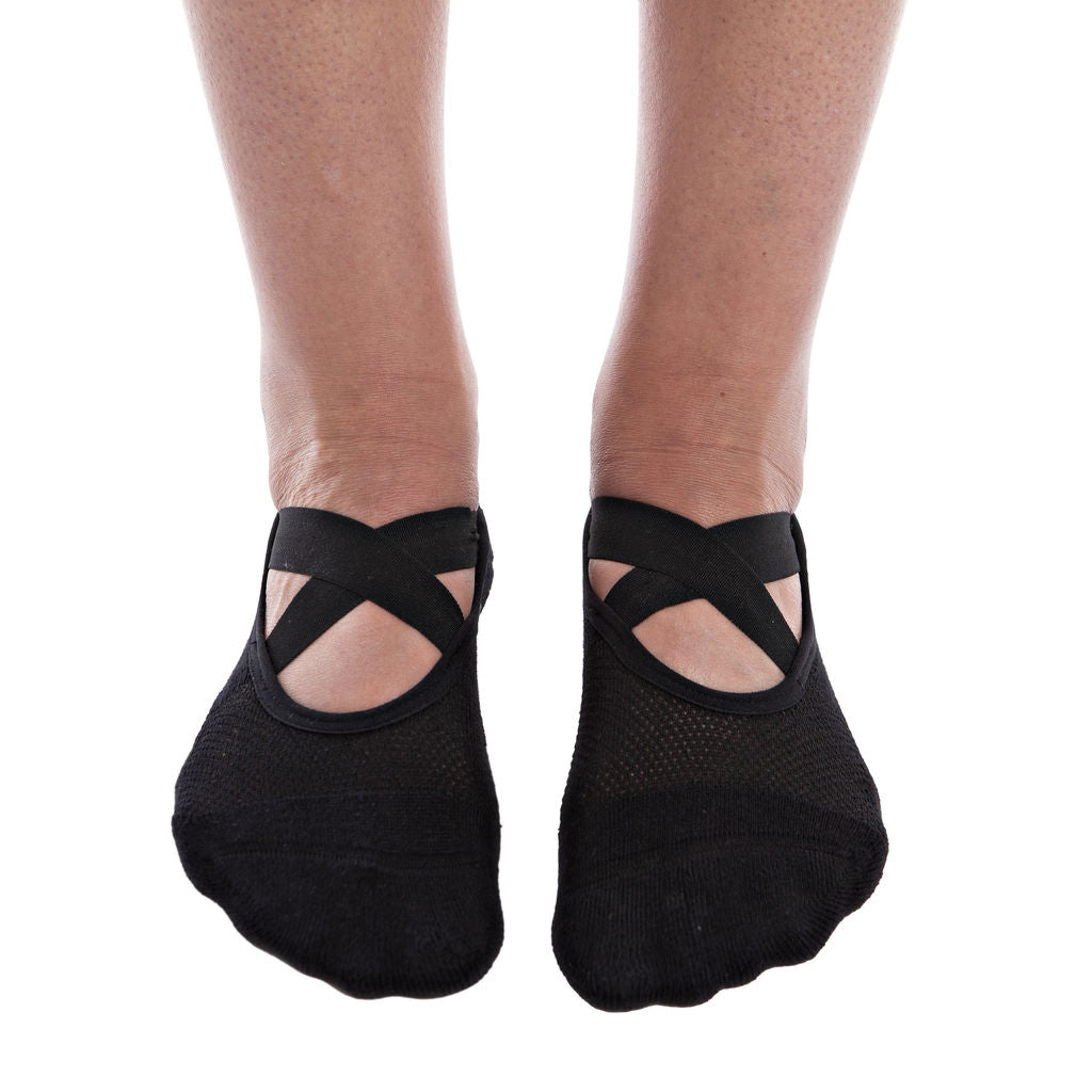 Black ballet-style grip socks on a white background