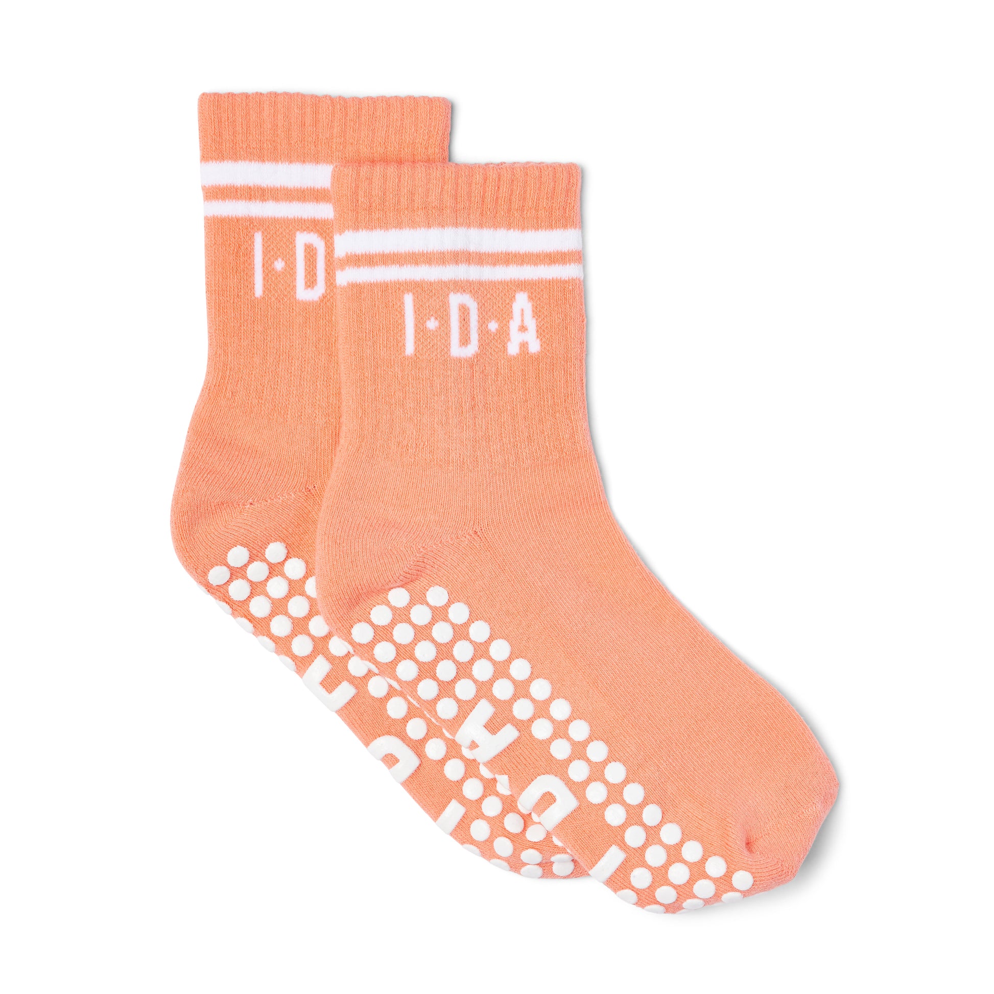 Pair of peach-colored socks with white grip sole 