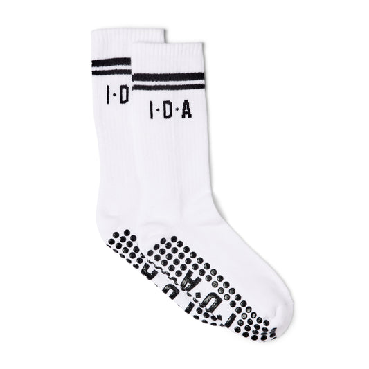 White socks with black grip non-slip sole on a white background